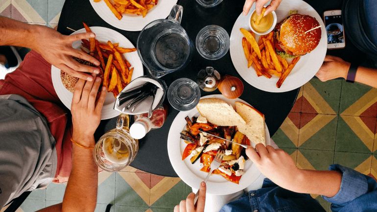 group of friends eating burgers and chips