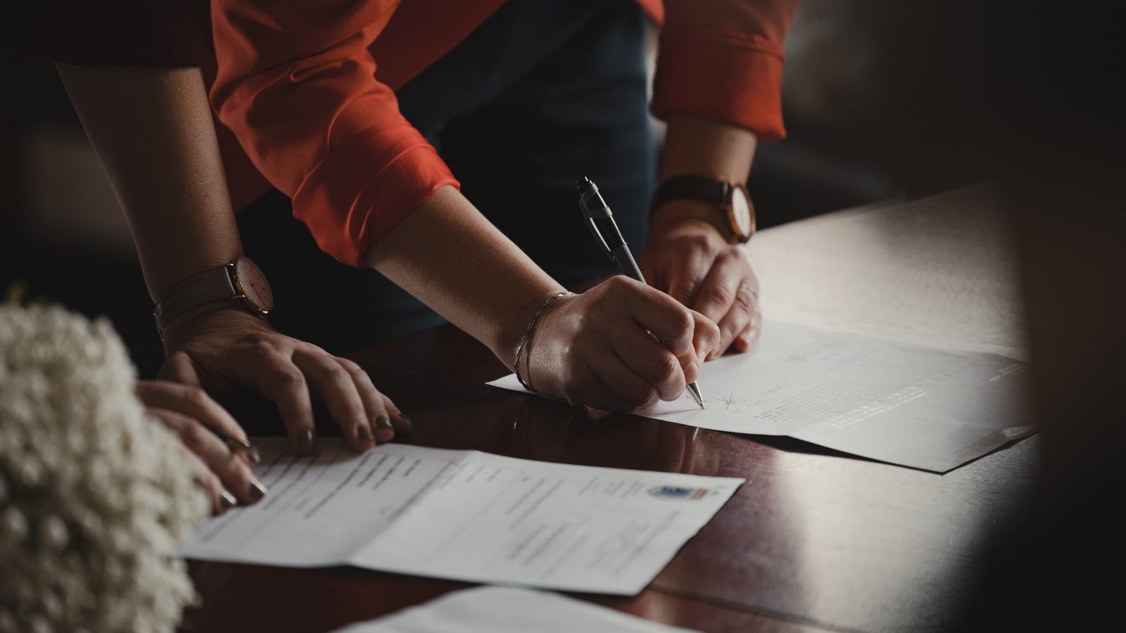 a woman signing documents